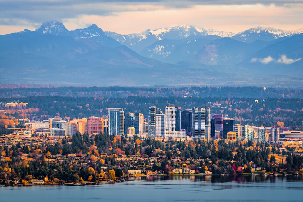 Bellevue Washington. The snowy Alpine Lakes Wilderness mountain peaks rise behind the urban skyline.