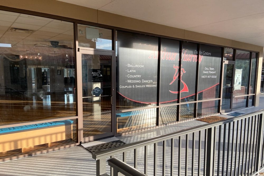 A bird's eye view of the cityscape of Clermont, Florida under a cloudy blue sky